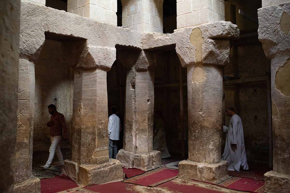 Worshippers walk among ancient pillars in the newly restored Church of the Virgin Mary at Jabal at-Tayr.