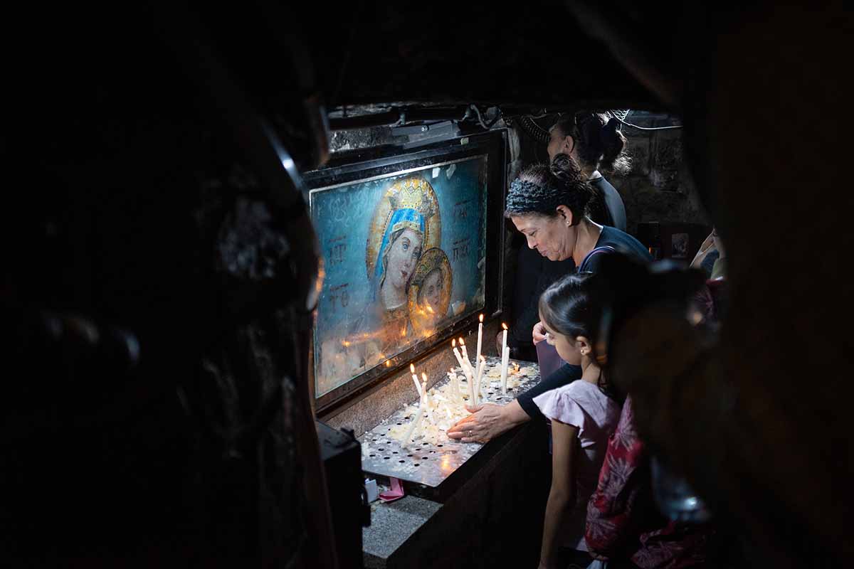 Worshippers move through the sacred crypt of the historic church of Mostorod, north of Cairo.