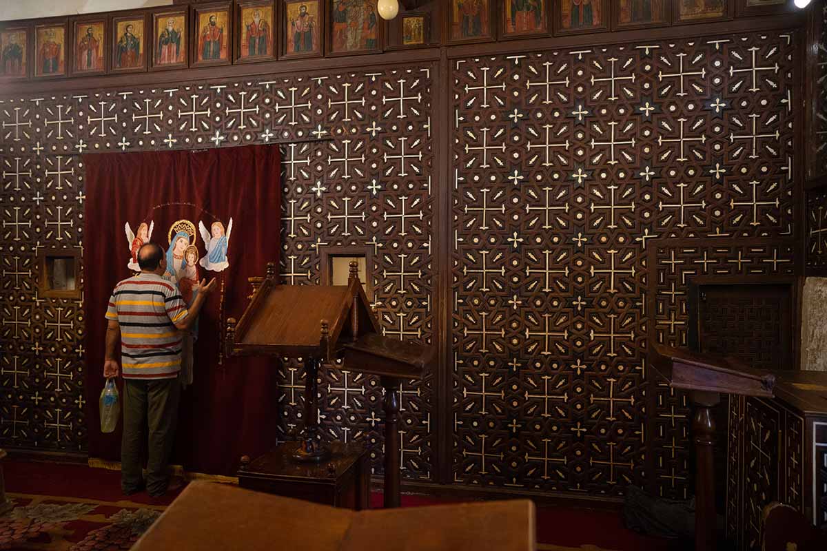 Deir al-Muharraq worshipper and iconostasis, Egypt