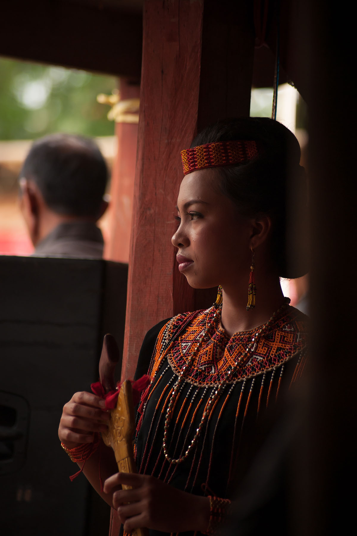 Family member in traditional dress at a Tana Toraja funeral, Sulawesi