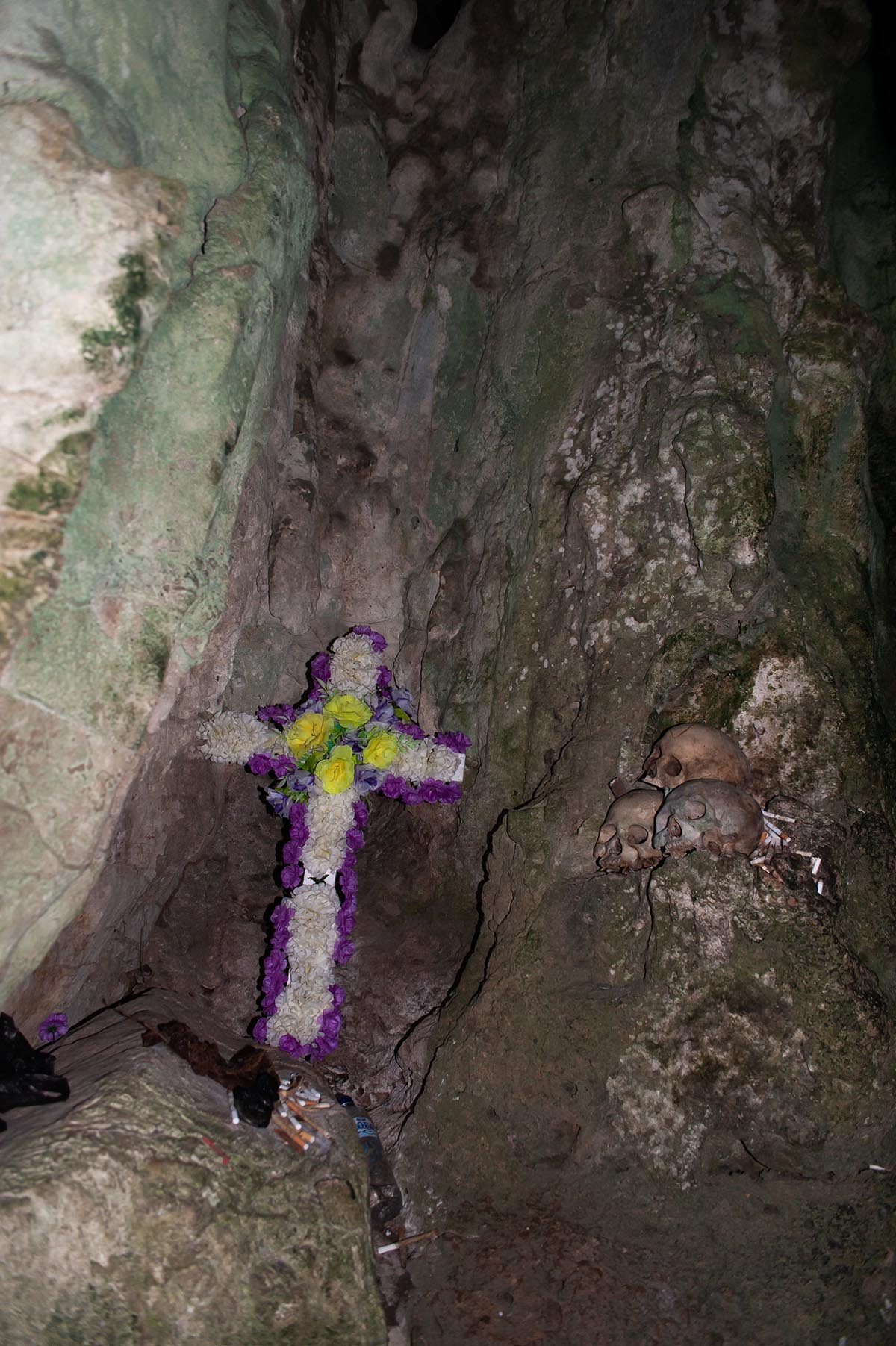 Burial cave with skulls and a crucifix in Tana Toraja, Sulawesi