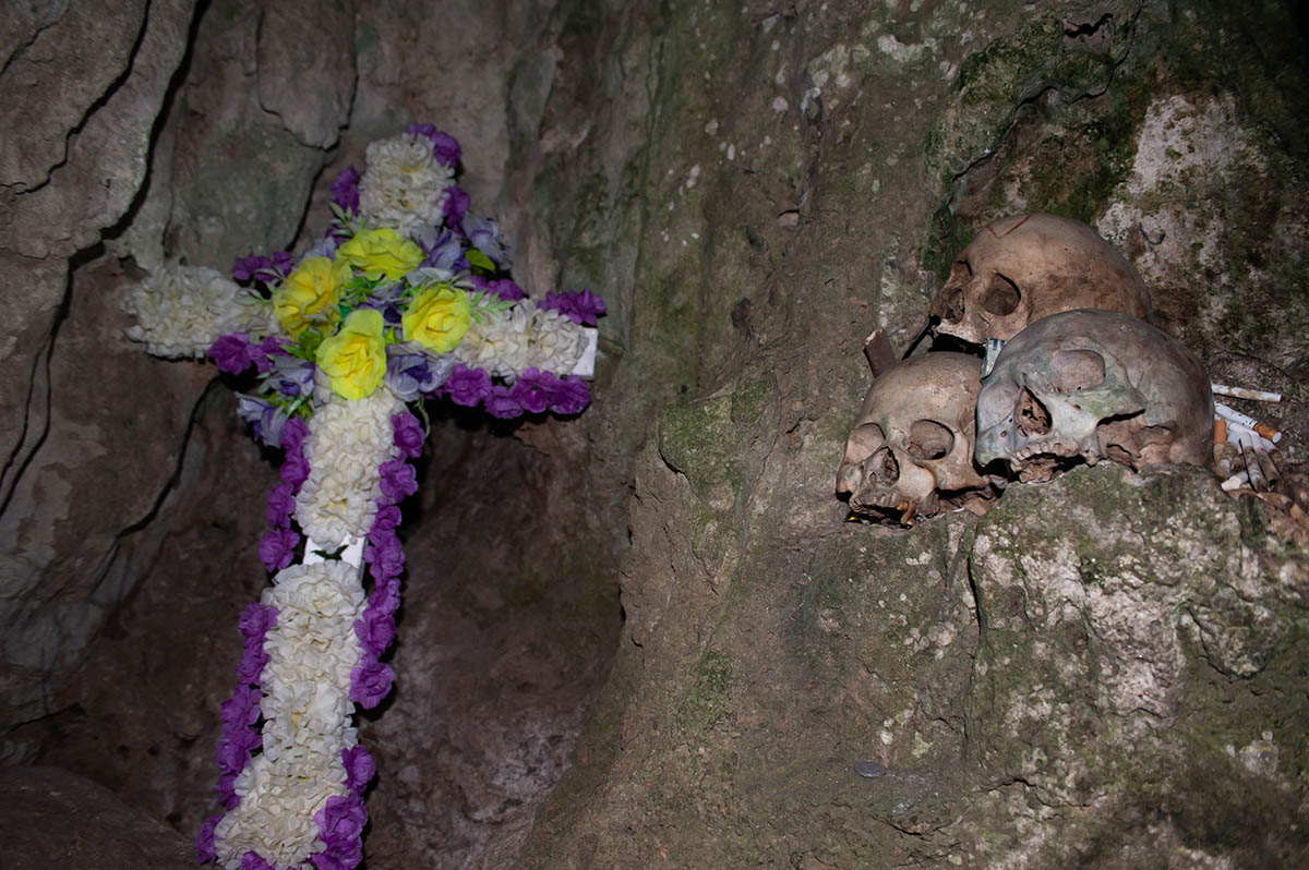 Skulls and a crucifix in a burial cave in Tana Toraja (Sulawesi)